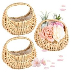 two baskets with flowers on them sitting next to each other