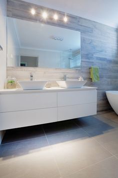 a bathroom with two sinks and a bathtub