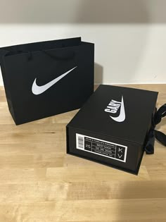 a black box with a white nike logo on it and a black bag that says nike