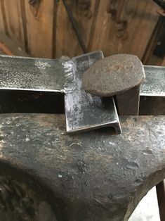 a metal object sitting on top of a wooden table