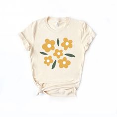 Looking for a cute versatile top to wear this summer? Make sure to grab one of our Yellow Daisies tees! This soft and comfortable graphic tee is the perfect top for any outfit. It can be paired with biker shorts, jeans, or even a simple skirt/dress! This tee is true-to-size, so be sure to order your regular t-shirt size! If you are looking for a more oversized look, make sure to size up! Everyday Graphic Tee For Spring, Summer Graphic Tee T-shirt For Everyday, Summer Graphic Tee For Everyday, Graphic Tee T-shirt For Summer Everyday Wear, Spring Graphic Tee With Print, Spring Graphic Tee Cotton Tops, Spring Cotton T-shirt With Graphic Print, Soft-washed Tops For Spring And Summer, Yellow Printed Relaxed Fit T-shirt