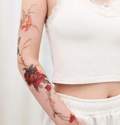 a woman with tattoos on her arm and arms