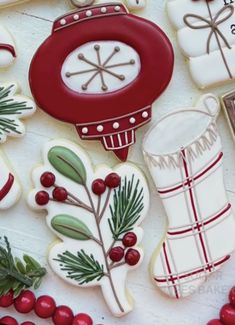 decorated christmas cookies and decorations on a table