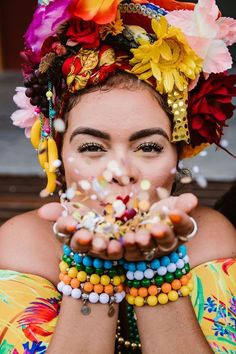 a woman with lots of bracelets on her face and hands in front of her face