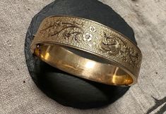 "Lovely Gold filled engraved rose bangle.  Condition is very good for its age, any slight wear commensurate with age, clasp works-images show the elegant design and nice condition, it is signed B Co.- 1/20 12K.  Size inner diameter approx 6 3/4\", width 5/8\" or 16mm, safety chain for added security, wt.- 24.3 grams.  Great design and easy to wear." Antique Etched Gold Bangle Bracelet, Antique Round Cuff Bracelet For Wedding, Antique Engraved Gold Bracelet For Wedding, Antique Etched Bangle For Wedding, Antique Etched Bracelets For Wedding, Vintage 14k Stamped Bangle For Weddings, Antique Hallmarked Bangle For Weddings, Heirloom Etched Bangle For Ceremonial Occasion, Antique Etched Wedding Bangle