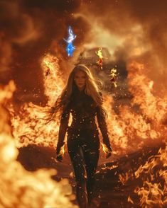 a woman is walking in front of fire