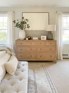 a bed room with a neatly made bed and a large mirror on the wall above it