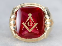 "This large vintage red glass Masonic ring has amazing, yet simply detailed shoulders, rising up from the shank and bending around the corners of the stone. The center is a classic red glass cabochon, inlaid with the gold Masonic symbol, with a nice flat profile. This ring has a substantial feel to it, and makes for a classic Masonic piece! Metal: 14K Yellow Gold Gem: Red Glass Cabochon, Gold Inlaid Masonic Symbol Gem Measures: 16mm x 14mm, Square Cushion Cut Size of Ring: 10 Marks: \"14K\" and Antique Red Signet Ring For Anniversary, Classic Red Signet Ring For Formal Occasions, Heirloom Red Signet Ring With Polished Finish, Classic Red Intaglio Jewelry, Heirloom Red Ruby Ring For Formal Occasions, Vintage Red Hallmarked Signet Ring, Collectible Red Rings With Polished Finish, Fine Jewelry Red Cabochon Ruby Ring, Collectible Red Engraved Ring