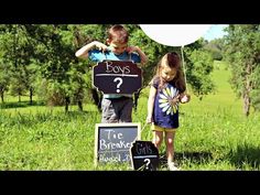 two children are standing in the grass with signs that say boys and one girl is holding a balloon