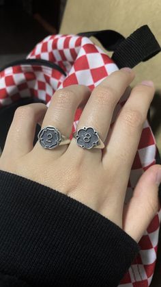 a woman's hand with two rings on top of her finger and an elephant ring in the middle