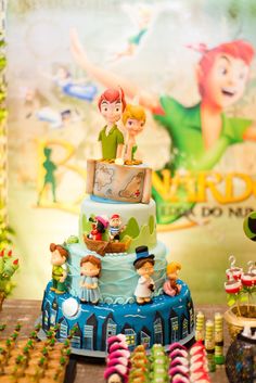 there is a cake with many figurines on it