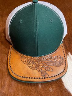 Richardson hat with a hand-tooled leather bill that has been hand sewn to the original bill. Country Style Leather Hat With Flat Bill, Leather Cap For Fall, Leather Hats For Fall Country Events, Custom Adjustable Leather Hats, Leather Snapback Hat, Artisan Leather Hat For Rodeo, Artisan Leather Brimmed Hats, Rustic Leather Hat For Fall, Country Style Leather Cap