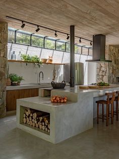 a kitchen with a stove, counter and chairs