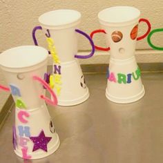 four plastic cups with numbers and stars on them