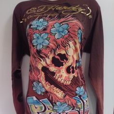 a woman's shirt with a skull and flowers on it