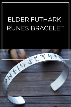 a cuff bracelet with the words elder futhark written on it and an arrow