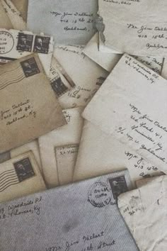 old letters and envelopes are piled on top of each other