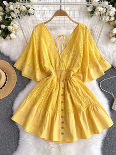 Envelop yourself in the romantic elegance of this beautiful yellow dress. Its lace detailing exudes a sophisticated charm, while the deep yellow shade offers a cheerful pop of color. The skirt flares out from a figure-hugging waist, creating a flirtatious and flattering profile. The bodice is graced with a line of delicate buttons, leading down to a ruffled hem that adds a touch of playful femininity. The open back, tied together with slender straps, offers a glimpse of skin in a tasteful displa Yellow Lace Patchwork Summer Dress, Yellow Lace Patchwork Dress For Summer, Elegant Yellow Beach Dress, Yellow Lace Mini Dress For Summer, Yellow Lace Patchwork Dresses, Yellow Lace Dresses With Lace Patchwork, Yellow Party Dress With Lace Patchwork, Elegant Yellow Mini Dress For Beach, Elegant Yellow Beach Mini Dress