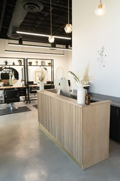 the reception desk is made from plywood and has gold trimmings on it