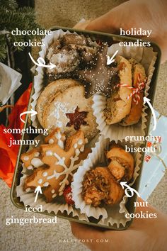 a box filled with lots of different types of cookies and pastries on top of each other