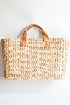 This airy, straw tote bag is finished with natural leather handles and a classic linen lining. Versatile and stylish, it's the perfect partner for airy dresses, summer prints or white denim. Content:- Straw- Leather - Linen Lining- Imported Size:- Width: 18.25" - Height: 12"- Depth: 6.59"- Handle Drop: 4.5" French Market Bag, Suede Tote Bag, Summer Tote Bags, Basket Tote, Suede Tote, Straw Tote Bag, Boho Bags, Perfect Partner, Raffia Bag