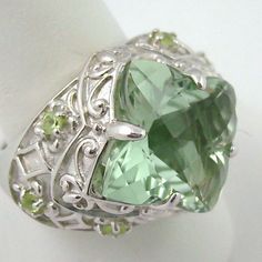 ******Price Is Firm - Final Sale****** Victoria Wieck 6.1ct Prasiolite & Peridot Sterling Silver Ring. Checkerboard-Faceted, Rounded, Geometric Prasiolite (16mm) In Prong Setting. Four-Lobed Frame Features Fleur-De-Lis Designs And Scrolling Metalwork Detail. Wide Shoulders Engraved With Diamond Shapes And Four-Lobe Patterns Accented With Prong-Set, Round Peridot (2mm) Gems. Ring Measures Approx. 11/16" L X 15/16" W. Boxed. Elegant Green Multi-stone Gemstones, Elegant Green Amethyst Ring In Sterling Silver, Formal Green Amethyst Jewelry, Formal Green Amethyst Ring With Accent Stones, Elegant Multi-stone Peridot Gemstones, Fine Jewelry Peridot Gemstones For Formal Occasions, Formal Peridot Gemstones For May Birthstone, Formal Green Amethyst Ring With Gemstone Accents, Elegant Peridot Gemstones For Anniversary