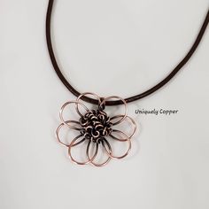 This gorgeous copper flower necklace is a perfect gift for your 7th Anniversary, Copper Anniversary, 22nd Anniversary, or as a gift for that special women in your life! The copper flower has been hand shaped, hammered, and wire wrapped to create the beautiful center of this copper pendant. It measures approximately 2 inches wide and 2 inches long. It has been antiqued and polished to a beautiful shine and is clear coated to protect the antique finish. It comes with your choice of either a black, Copper Flower Pendant Necklace As Gift, Brown Flower-shaped Jewelry Gift, Hand Forged Flower Pendant Necklace As Gift, Rose Gold Copper Wire Necklace Gift, Rose Gold Copper Wire Necklace For Gift, Handmade Flower Pendant Necklace For Anniversary, Hand Forged Flower Jewelry Gift, Flower Shaped Hand Forged Jewelry Gift, Hand Forged Flower Shaped Jewelry Gift