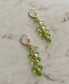 These are peridot drop earrings using 9 pear shaped stones in each, and wire wrapped with 14 k gold filled. They hang about 2.25 inches and are really easy to put on, using a lever back closure. Great the for the up coming holidays, great for gifts and great for evening wear. Not too long, not too short, they're just right. peridot drop earrings peridot and gold dangling earrings holiday earrings August birthstone earrings Long Green Earrings, Green 14k Gold-filled Dangle Earrings, Green 14k Gold Filled Dangle Earrings, Green 14k Gold Filled Earrings With Ear Wire, Peridot Dangle Earrings In Gold, Green Peridot Dangle Earrings, Green Teardrop 14k Gold Filled Earrings, Yellow Gold Peridot Dangle Earrings, Peridot Dangle Earrings With Ear Wire