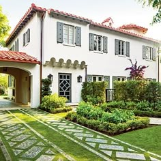 a large white house surrounded by lush green grass