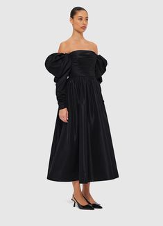 PRODUCT DESCRIPTION Premium off-shoulder gownStrapless necklineZipper detail necklineFitted ruched bodiceGathered puff sleeveElastic shoulderRuched zip cuff openingInvisible back zip closurePleated A-line silhouetteFully lined SIZE & FIT 6 8 10 12 14 16 Collar 77.5 82.5 87.5 92.5 98.5 104.5 Bust 80 85 90 95 101 107 Waist 67 72 77 82 88 94 Sleeve Length 47 47 47 47 47 47 Sleeve Opening 18.5 19.5 20.5 21.5 22.5 23.5 Back Length 109.8 111 112.2 113.4 114.6 114.6 Hem Circumference 471 475 479 483 487 494 Model is 5’10” (178 cm) and wears a size 8Bust: 31.5” (80cm) / Waist: 24” (61cm) / Hips: 36” (91cm) Evening Off-shoulder Ruched Midi Dress, Formal Dress With Ruched Bodice And Puff Sleeves, Formal Puff Sleeve Dress With Ruched Fitted Bodice, Puff Sleeve Dress With Ruched Bodice For Formal Occasions, Evening Midi Dress With Gathered Neckline, Formal Puff Sleeve Ruched Dress With Fitted Bodice, Ruched Off-shoulder Evening Dress, Evening Dress With Gathered Neckline And Long Sleeves, Off-shoulder Formal Dress With Gathered Sleeves