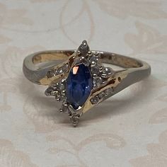 Lovely Vintage Sterling Silver Blue Tanzanite Halo Ring, Ladies Size 8 1/4 Faceted Marquis Cut Blue Gemstone is Prong Set and Surrounded by Prong Set CZ Stones. Open To Back. The Setting is Pretty With a Little Bit of a Crossover. Inside of Band is Marked 925 D Very Nice Condition With Minor Signs of Wear. Please See Photos For More Detail. Blue Gemstone Ring, Blue Gemstone Rings, Blue Tanzanite, Multi Stone Ring, Blue Gemstones, Halo Rings, Halo Ring, Vintage Ring, Cz Stone