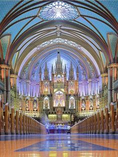 the inside of a large cathedral with stained glass windows