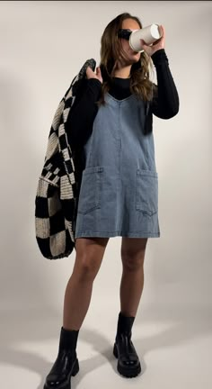 Overall Dress Winter Outfit, Sundress With Shirt Underneath, Dressed Up Overalls Outfit, Short Overalls Outfit Winter, Cardigan Over Overalls, Denim Dress Layering, Orange Overall Dress Outfit, Denim Overall Dress Outfit Winter, Short Simple Dresses Casual