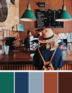 a woman standing in front of a counter with hats on