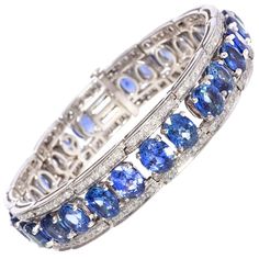 The blue sapphire bracelet features calibrated oval cut faceted Ceylon sapphires of splendid color for a total of approximately 35 carats. The design is complete with approximately 2 carats of top quality diamonds (color, clarity and cut, F/G-VVS). The bracelet was handmade by maestro Salvatore in 18 carat white gold in our own workshop in Italy, according to an original design by Ella Gafter. The item is signed EG. It is shown with LU80239204252 in the last image of the carousel. Ella Gafter on Argentium Silver Jewelry, Blue Sapphire Bracelet, Diamond Cuff Bracelet, Flexible Bracelet, Silver Tennis Bracelet, Bracelets Design, Sapphire Wedding, Sapphire Bracelet, Argentium Silver