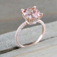 an engagement ring with a pink morganite surrounded by diamonds