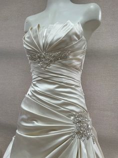 a white wedding dress on a mannequin