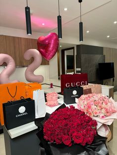 flowers and balloons are on the table at a gucci store