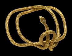 a gold snake on a black background