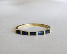 "Natural sapphire baguette eternity ring, five \\ seven stone ring made from 14K yellow gold.   A Unique minimalist ring design, the ring is set with with 5 baguette cut, blue sapphires.  Available also in other gold colors such as white gold or rose gold and also in 18K gold - please see all options and quoting in the drop down menu above. Ring description: * Dimensions: approx. 0.078\" / 2 mm. * Materiel: 14K gold. Stone: * 5 natural sapphires, baguette cut.  * TWC: approx. 0.75 CT  Variations Sapphire Baguette Band, Sapphire Channel Set Ring, Sapphire Baguette Ring, Baguette Eternity Ring, Sapphire Band Ring, Blue Sapphire Wedding Ring, Sapphire Eternity Ring, Infinity Band, Saphir Ring