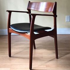 a wooden chair sitting on top of a hard wood floor