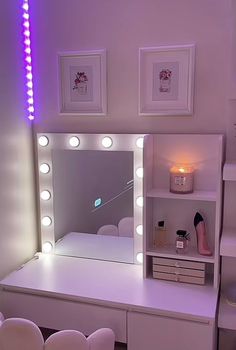 there is a vanity with lights on and a mirror in front of the desk area