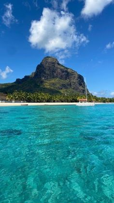 an island in the middle of clear blue water