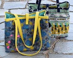 two bags sitting on the ground next to each other