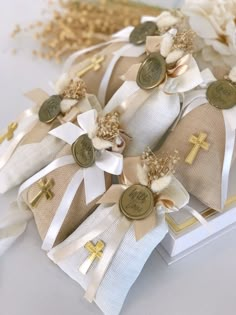 a bunch of white and gold ribbons with crosses on them