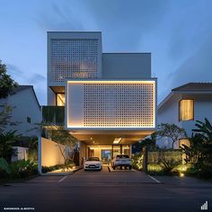 two cars are parked in front of a modern house at dusk with the lights on