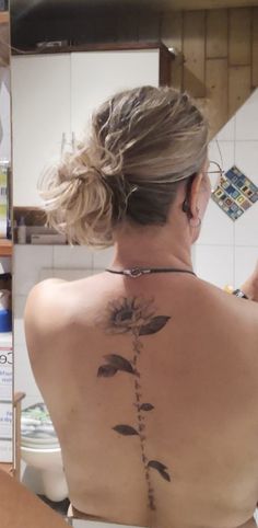 a woman with a tattoo on her back