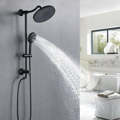 a shower head with water coming out of it and a white bathtub in the background