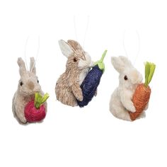 three small stuffed animals hanging from strings