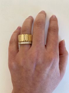 a woman's hand with a gold ring on it